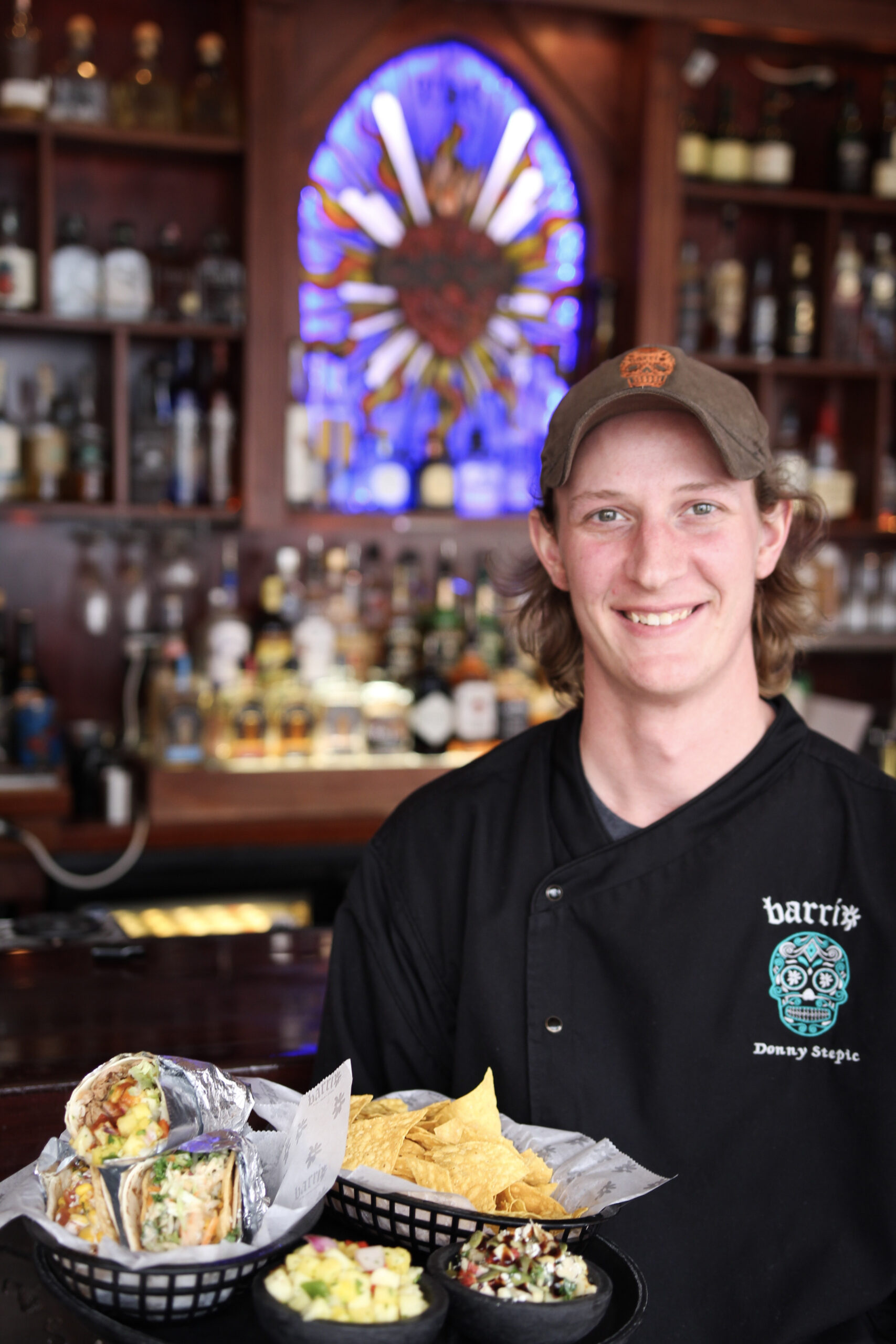 barrio server with tray of food